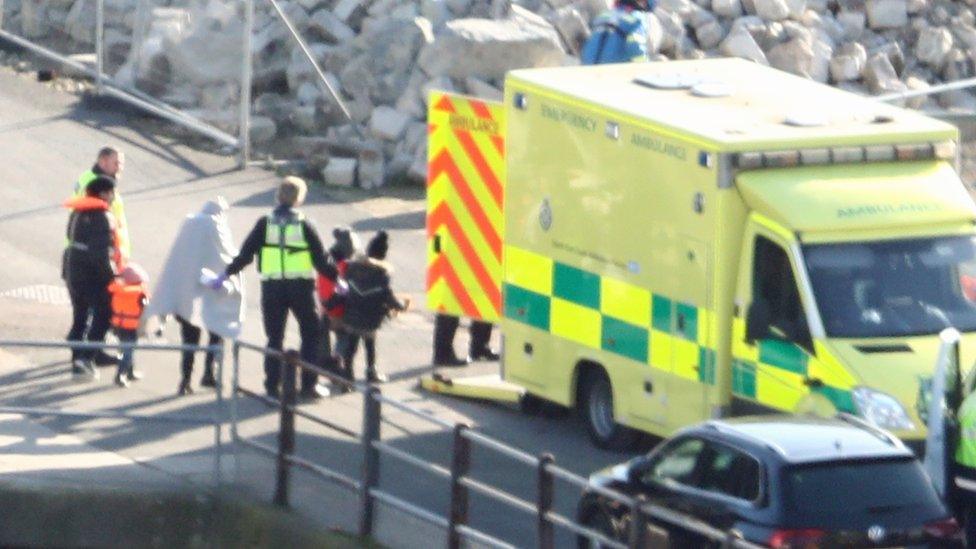 Migrants lead away in Dover