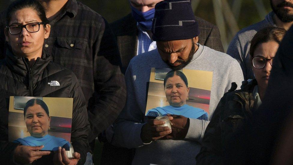 Family members show pictures of Jaswinder Kaur at a vigil