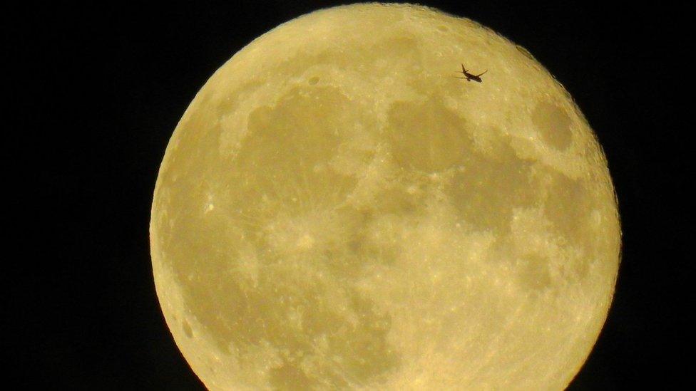 Aeroplane "photo-bombs" this picture taken over Beverley, Yorkshire. The aeroplane shadow can be seen on part of the moon.