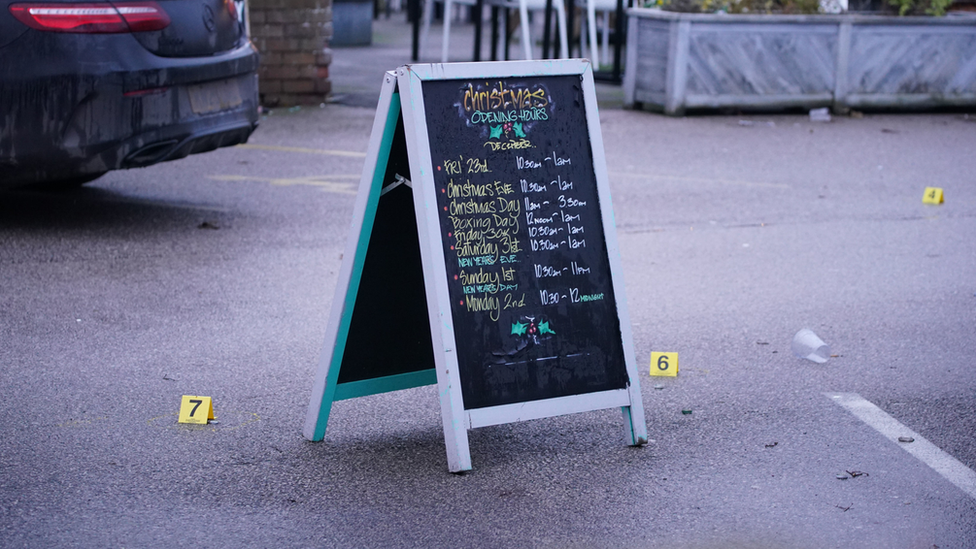 Evidence markers around a pub advertising board at the Lighthouse Inn