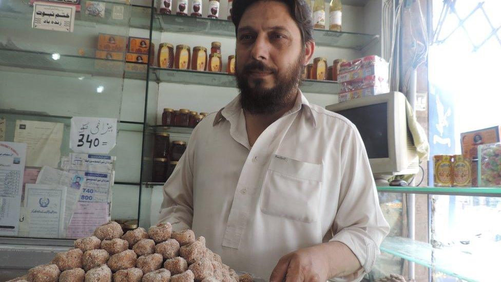 Ahmar Mehmood a.k.a. Ahmar Badayuni (sic), and a tray of Badauni pedhe - taken inside Badauni Pedha House, Bank Road, Mardan