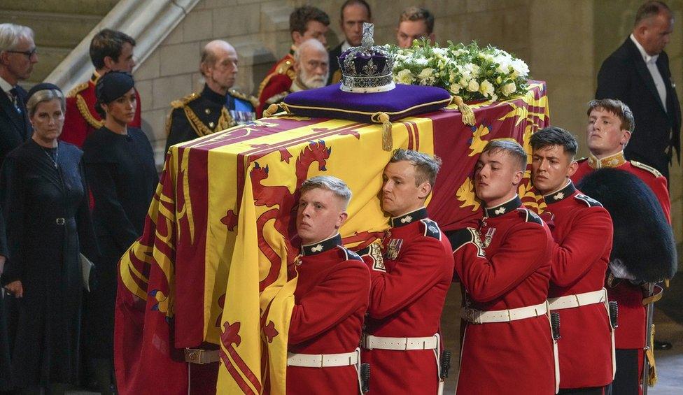 The Queen's coffin being brought into Westminster Abbey, with members of the Royal Family looking on