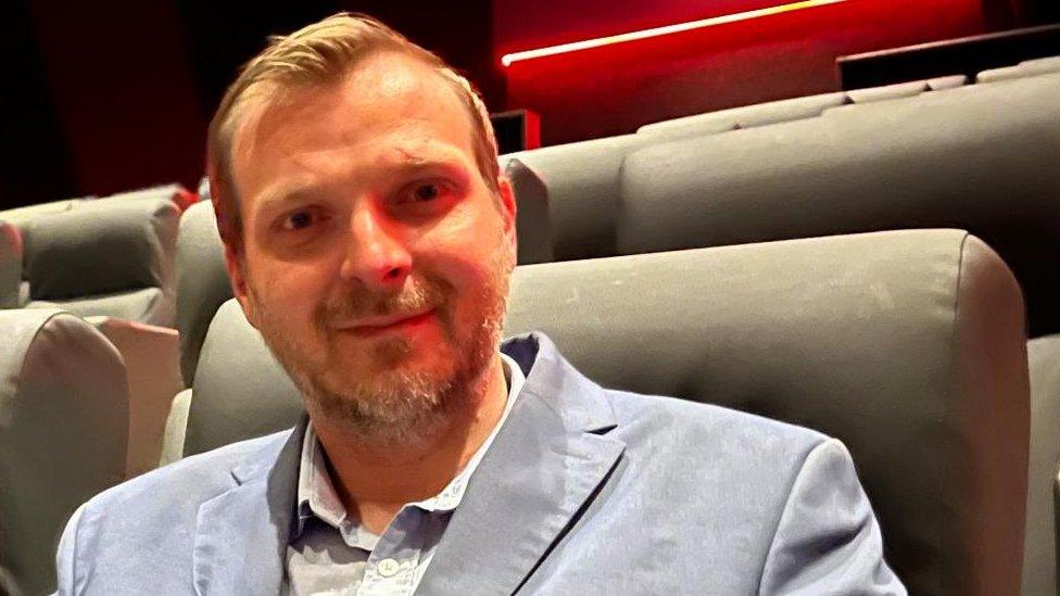 Cinema manager Derren Hodges seated in the auditorium.