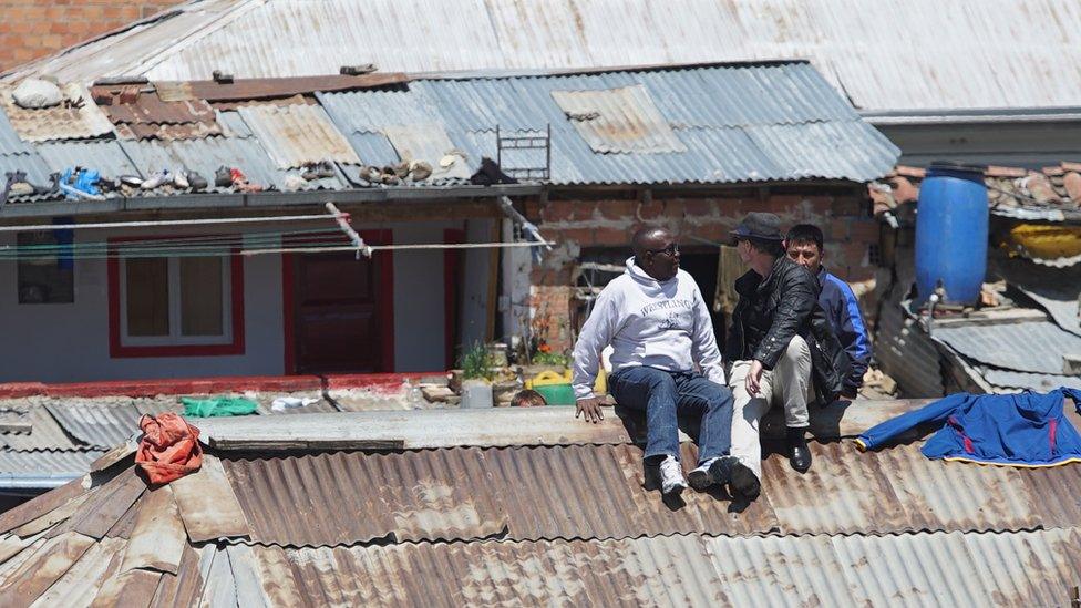 Thomas McFadden (left) and Rusty Young (centre) sitting on the roof of San Pedro Prison on their recent return