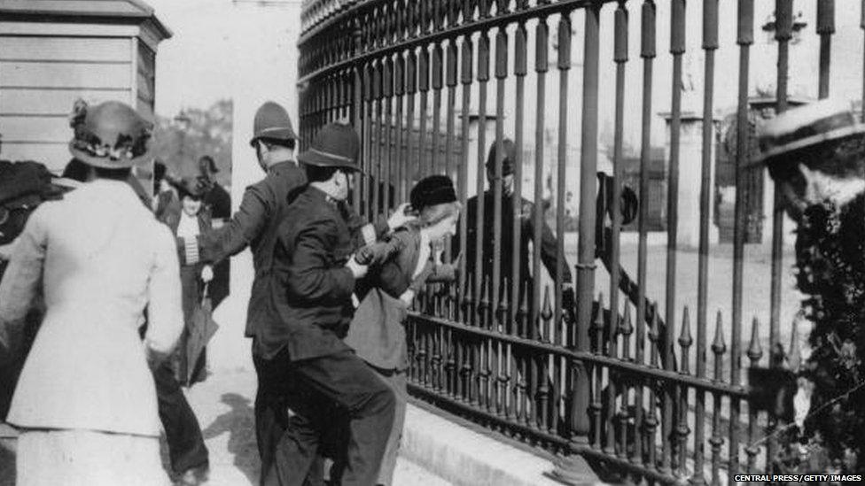 A woman fighting with police officers