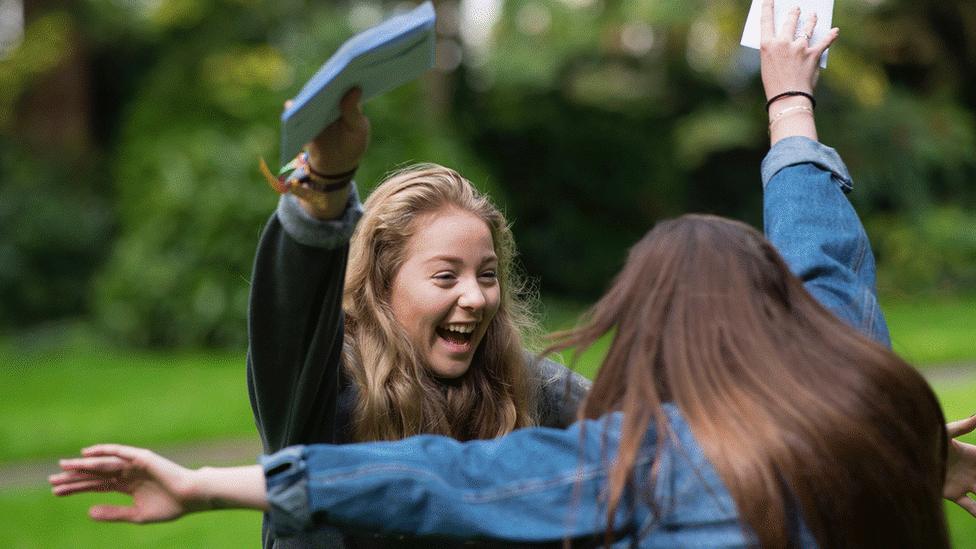 Imogen Lloyd (L) celebrates with Hollie Jones after receiving her GCSE results at Ffynone House School, Swansea