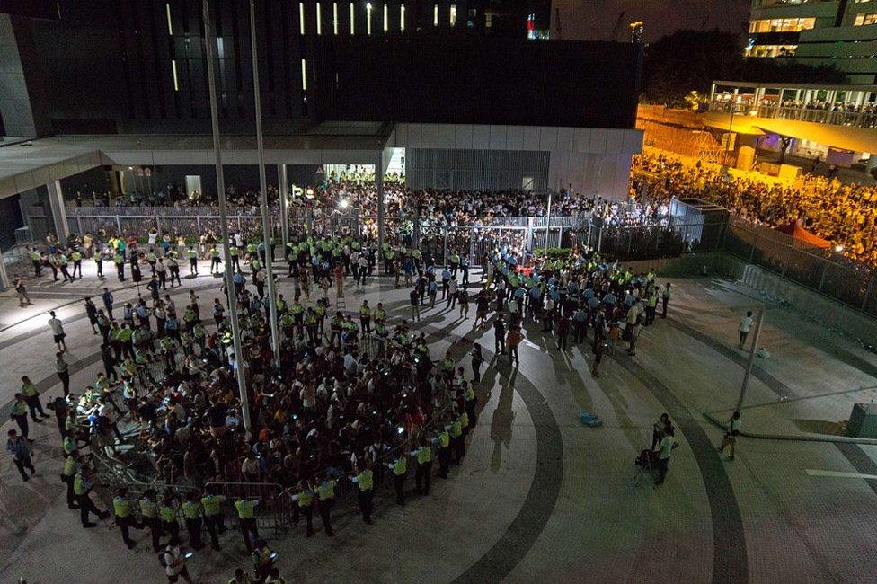 Student pro-democracy demonstrators are surrounded by police after storming into a courtyard outside Hong Kong's legislative headquarters on 26 September 2014.