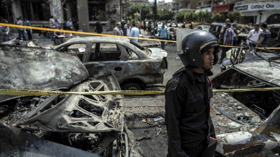 In this Monday, June 29, 2015, file photo, an Egyptian policeman stands guard at the site of a bombing that killed Egypt’s top prosecutor, Hisham Barakat, in Cairo, Egypt.