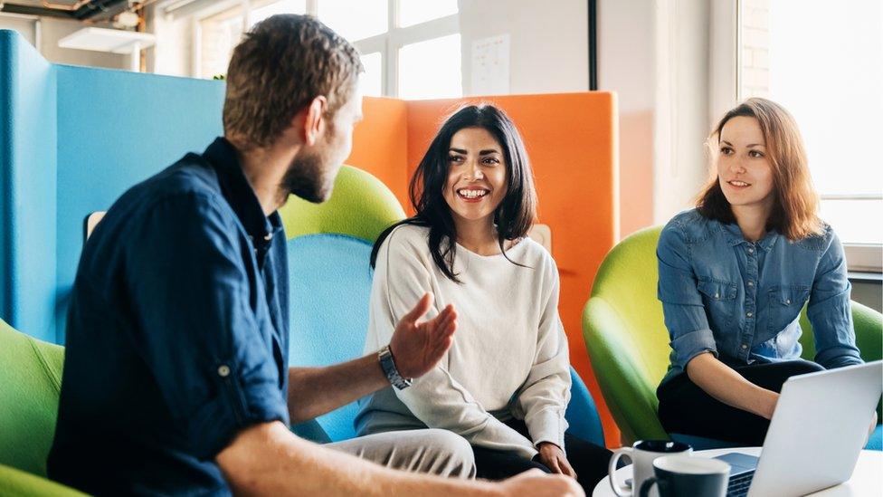 People sat talking in an office