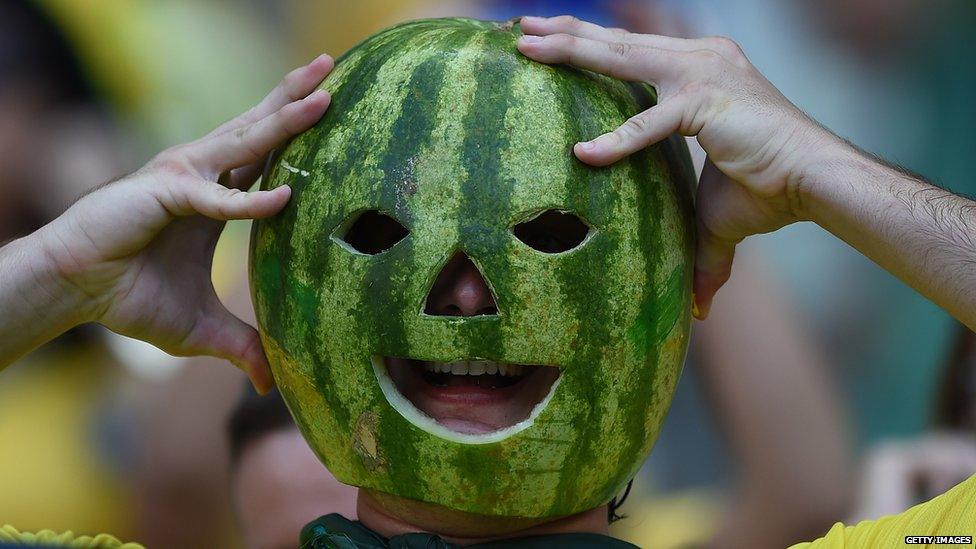 A man with a watermelon on his head