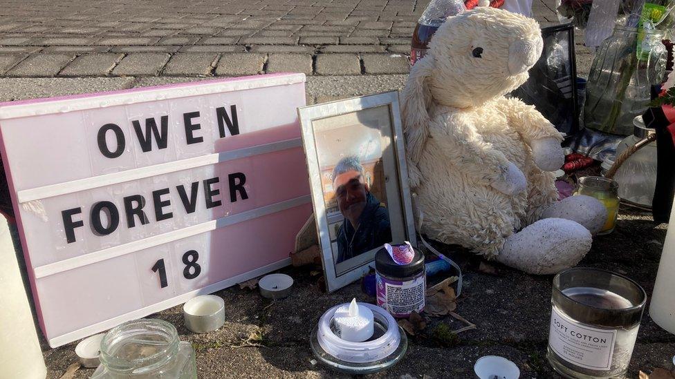 A memorial to Mr Dunn on Mazurek Way, Swindon where the teenager died including a rabbit teddy, a sign that says owen forever 18 and candles