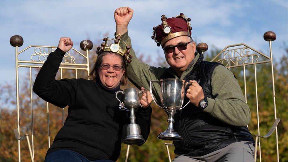 Women's champion Fee Aylmore and Mens champion Randy Topolnitsky from Calgary in Canada, winners at the annual World Conker Championships at the Shuckburgh Arms in Southwick