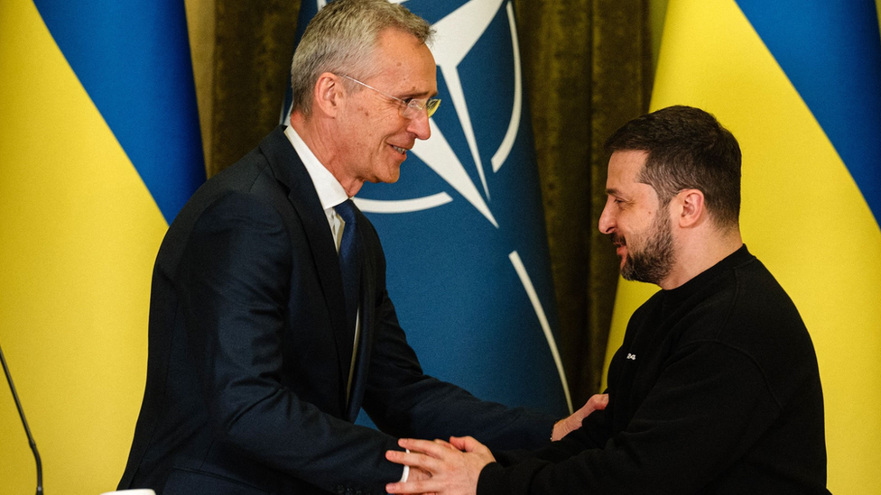 Former Nato secretary general Jens Stoltenberg and the Ukrainian President Volodymyr Zelensky smile as they shake hands in front of Nato and Ukrainian flags at a meeting in Kyiv in May 2023.