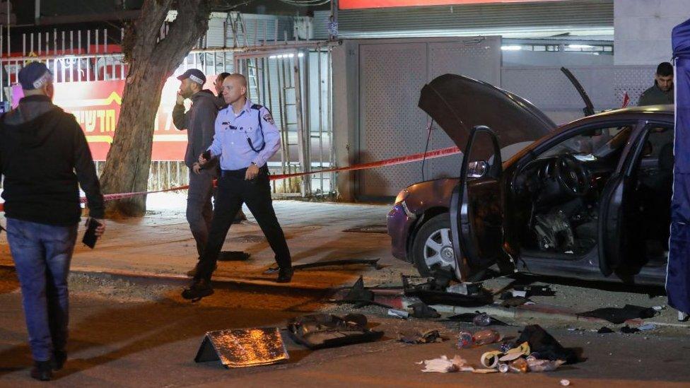 Israeli security forces gather at the site of an attack that left two people dead in the northern city of Hadera