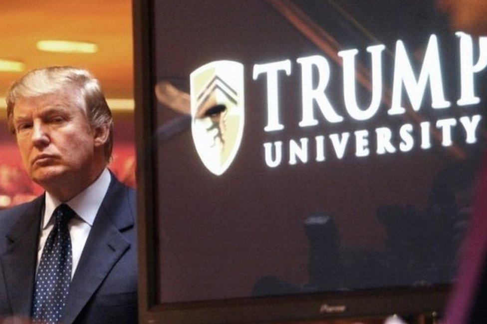 Donald Trump listens as Michael Sexton speaks at the launch of the Trump University investment school in 2005