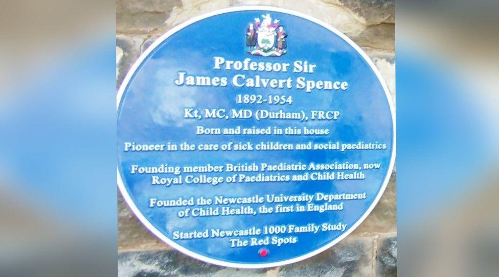 A close up of the blue plaque which describes the achievements of Professor Sir James Calvert Spence 