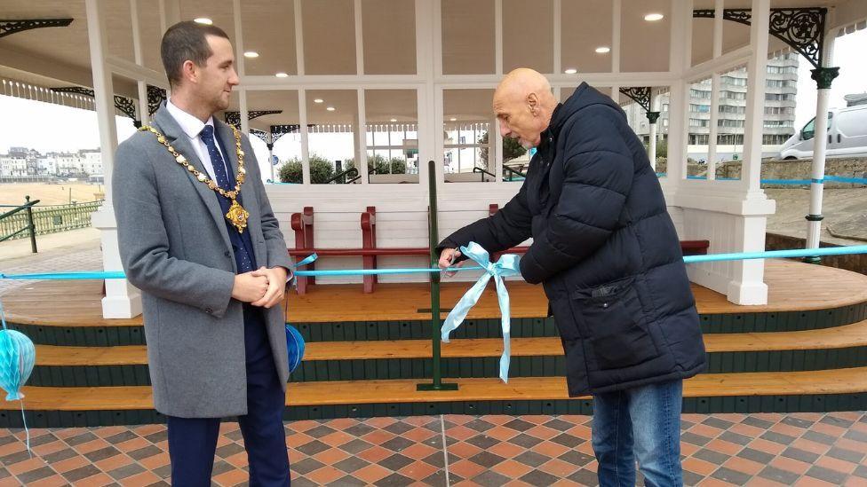 Councillor Steve Albon and Mayor of Margate, Jack Packman, cutting a blue ribbon outside the shelter. 