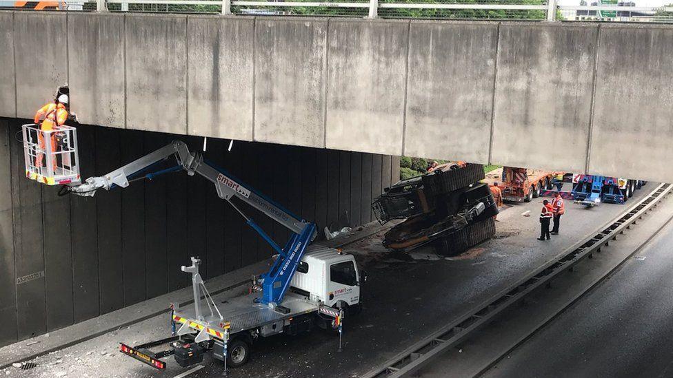 Highways officers at the scene of a crash under the A52 bridge near the QMC in Nottingham. 