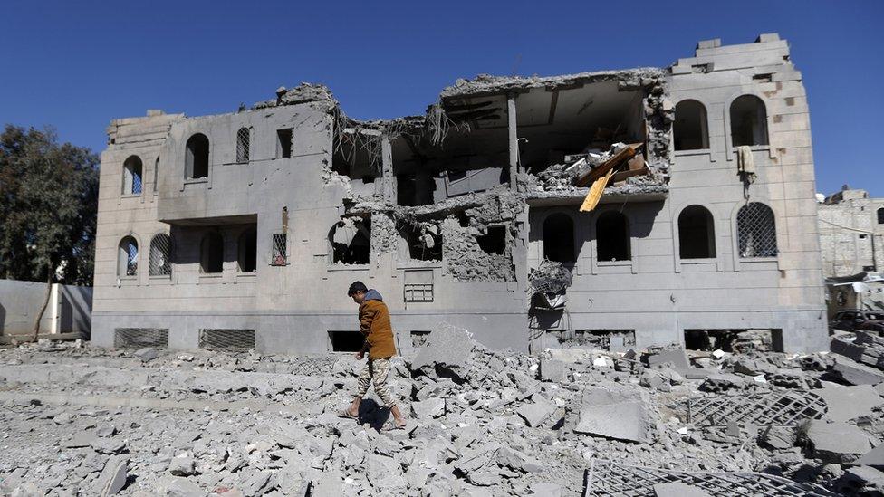 A Yemeni man checks the remains of a Houthi-run detention centre in the capital Sanaa after a Saudi-led coalition air strike (13 December 2017)