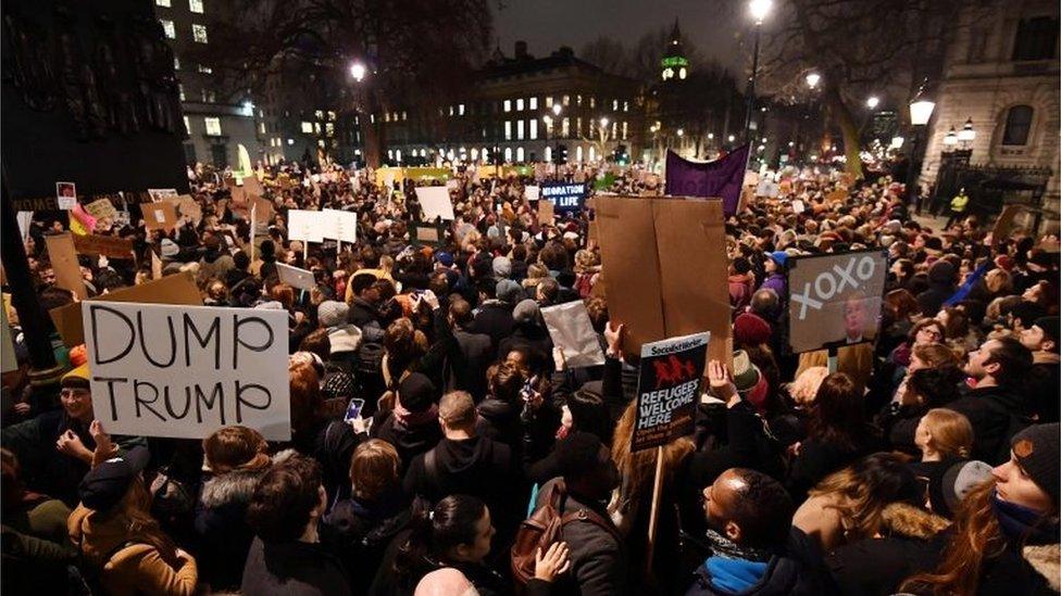 Demonstrators protest outside Downing Street against US President Donald Trump in central London on January 30, 2017