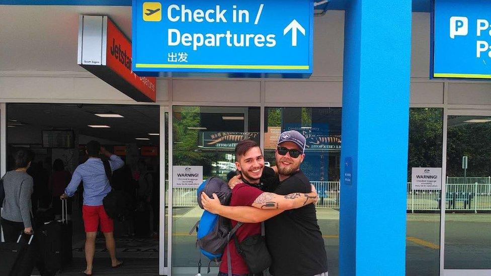 Two men both named Sam Mitchell share a hug at Launceston Airport. They met on Facebook.