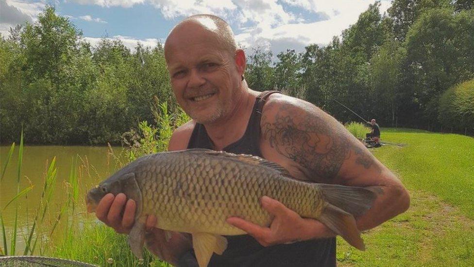 Christopher Kay holding a fish