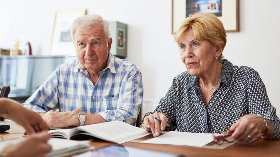 A photo of two people having a discussion