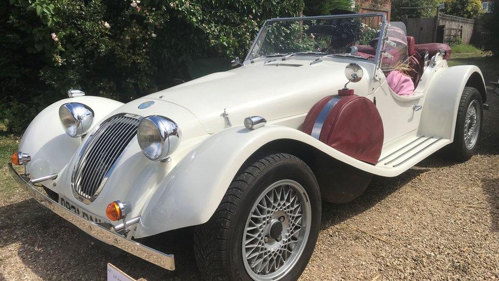 Scarecrow in a classic car