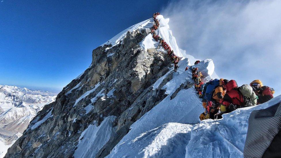 A photo from Nirmal Purja's Project Possible expedition shows a long queue of mountain climbers lining up to stand at the summit of Mount Everest