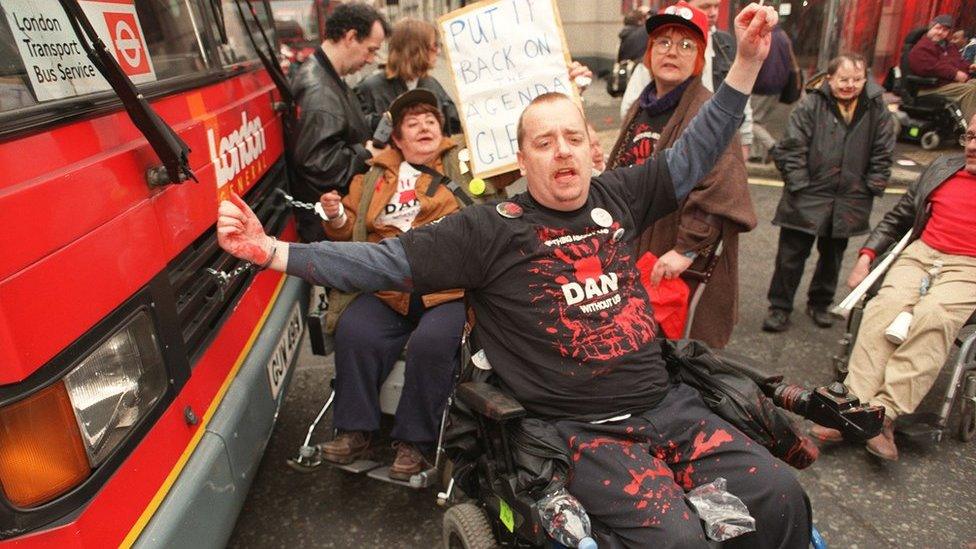 DAN protestors in front of a bus