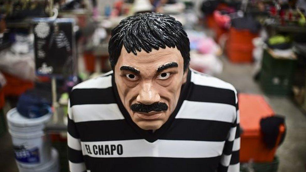 A costume and a mask representing Mexican drug trafficker Joaquin Guzman are pictured in a factory of costumes and masks, on October 16, 2015, in Jiutepec, Morelos State.