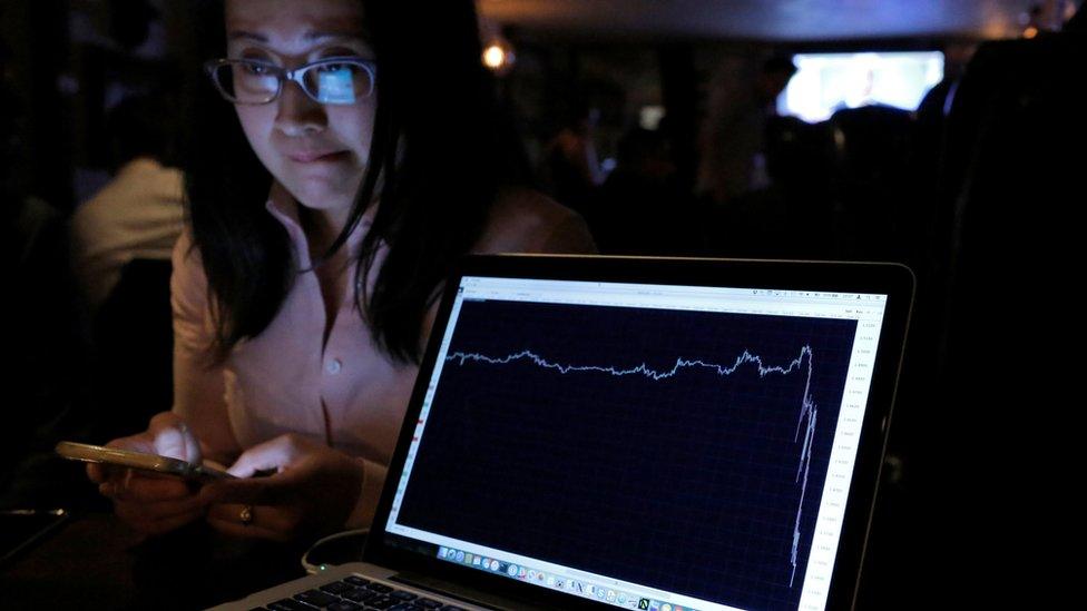 A woman watching the Brexit vote in The Churchill Tavern reacts as a graph shows the British Pound falling in value