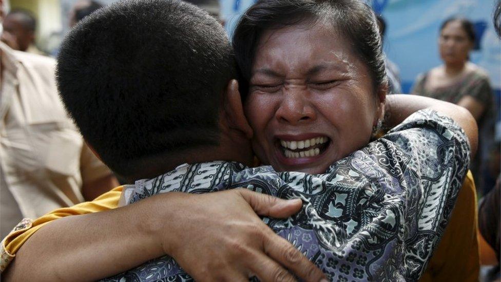 Woman cries after learning her brother died on the plane, Medan, Indonesia (2 July 2015)