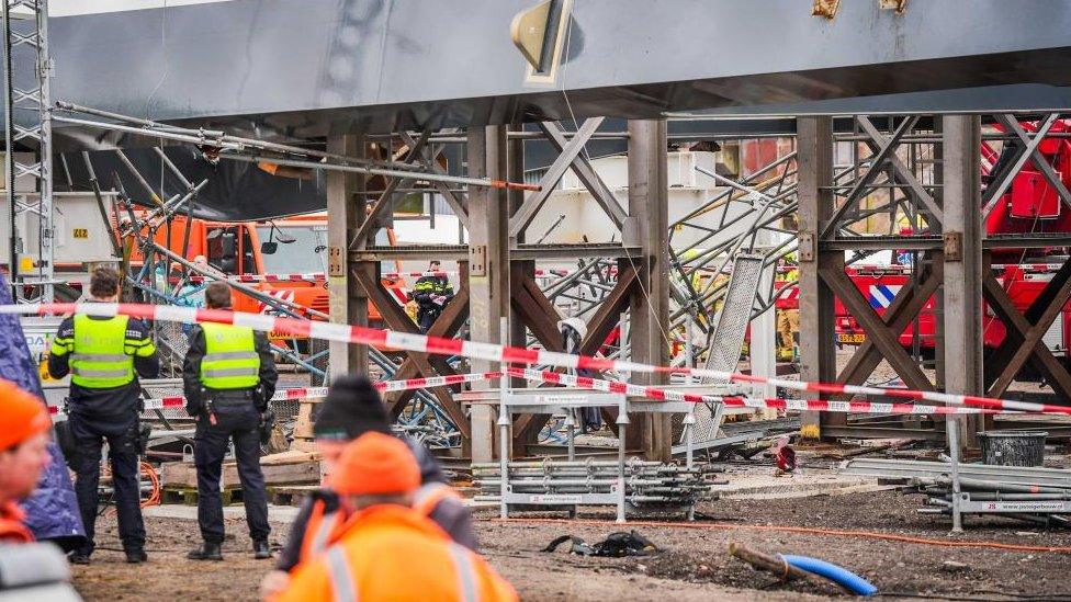 Part of a bridge under construction is taped off