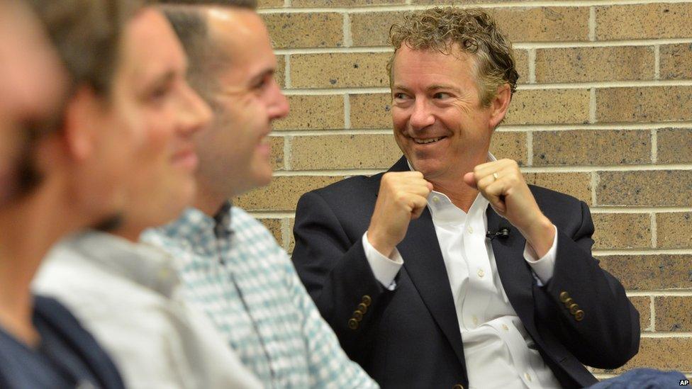 Republican presidential hopeful Sen. Rand Paul, pumps his fists in the air to encourage a small child who was talking as he was being introduced at a campaign event at Morningside College in Sioux City, Iowa, Wednesday, July 1, 2015