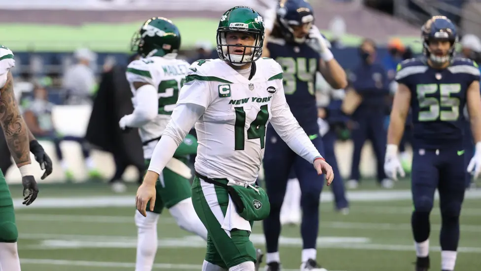 Sam Darnold walks off the field playing for the New York Jets