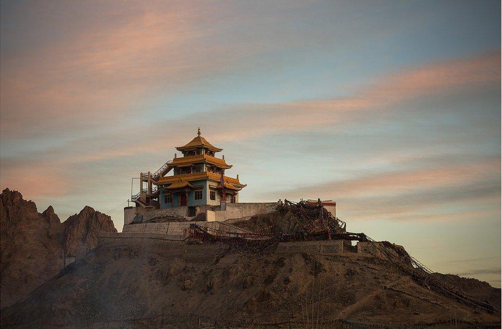 A Buddhist temple sits on top of a hill