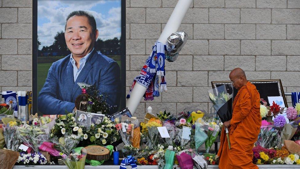 A Buddhist monk lay tributes by a photograph of Leicester City Football Club's Thai chairman Vichai Srivaddhanaprabha outside the club's stadium