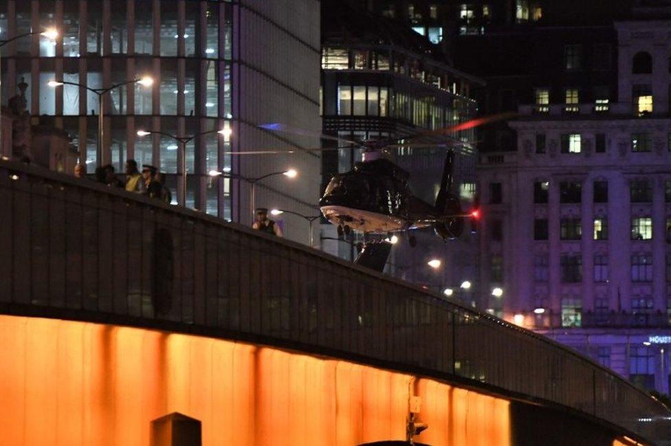 An emergency response helicopter lands on London Bridge