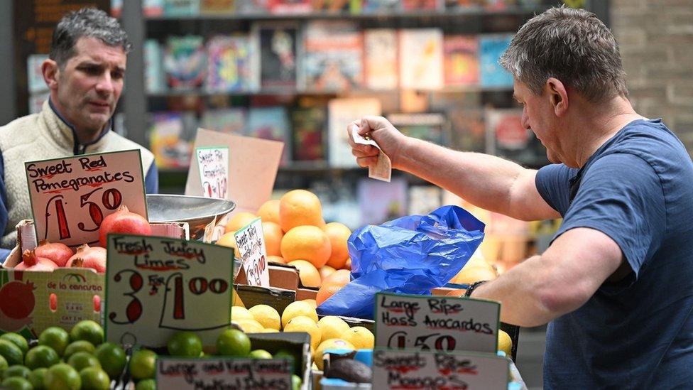 Two traders in a London market, one looking frustrated