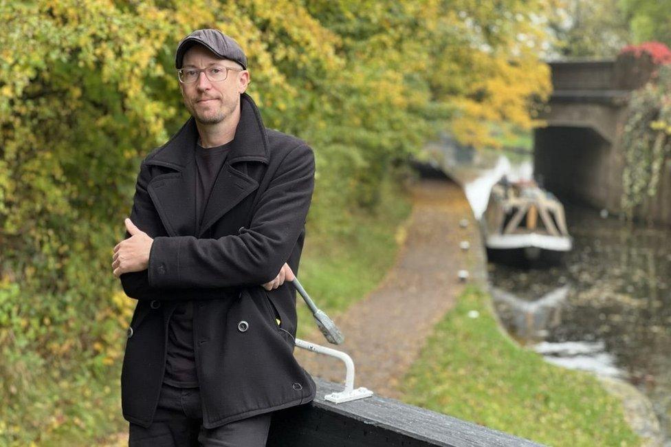 Robbie standing next to a lock