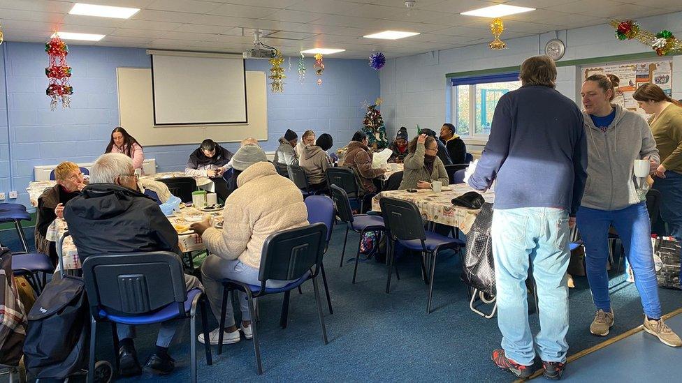 People sat at tables in the community cafe