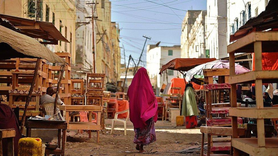 A woman walking through the streets of Mogadishu