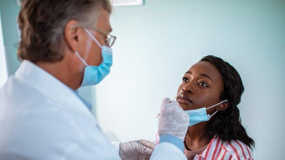 Doctor performs a PCR test on a patient