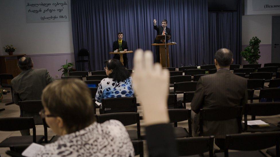 Witnesses discuss the Bible during a Jehovah's Witness meeting in Russia in 2015