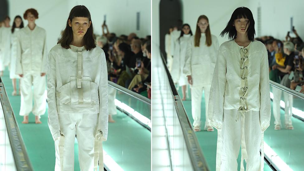 Two models wearing the 'straitjacket' jumpsuits on the catwalk