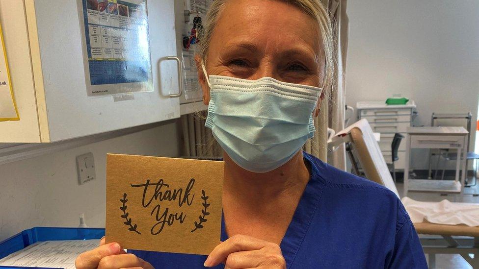 Nurse holding Thank You card