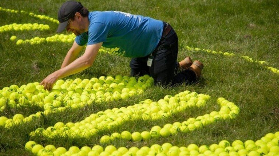 Giant tennis ball mosaic near No.1 Court showing Tefy from Madagascar enjoying clean water.