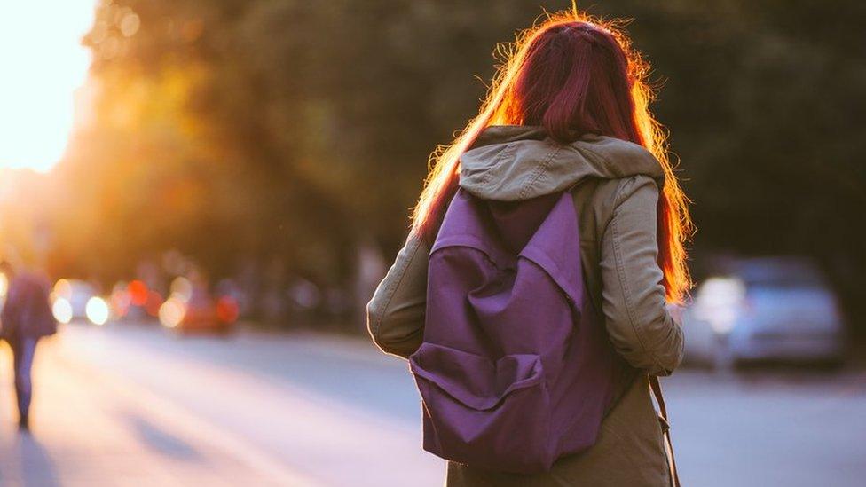 Teenager wearing school bag