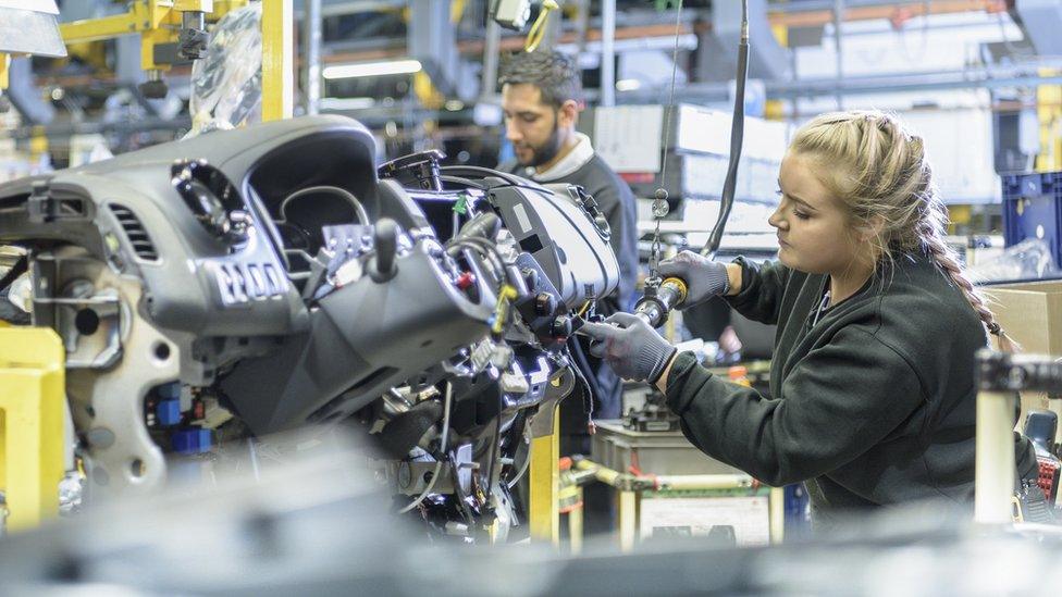 A young woman puts together a car dashboard